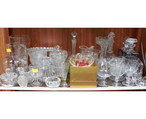 A shelf lot of assorted glassware.