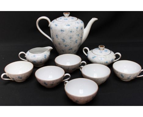 A Bavarian porcelain tea set, decorated with blue flowers and gilt highlights on a white ground, comprising six cups, tea pot