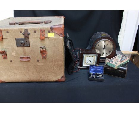 A large canvas covered travelling trunk and a small travelling trunk, together with a 1930s oak mantle clock, a Smiths Bakeli
