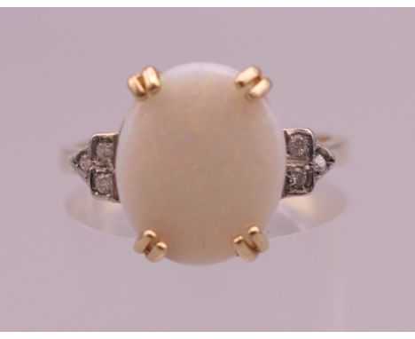 A 9 ct gold, opal and diamond ring. Ring size O/P. 2.8 grammes total weight.