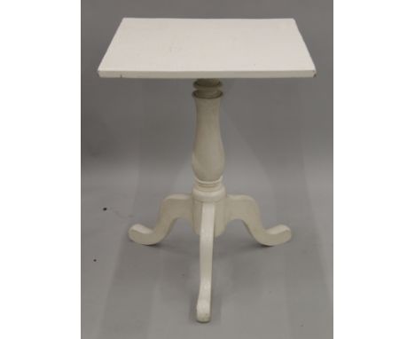 A white painted tripod table. 56 cm wide.