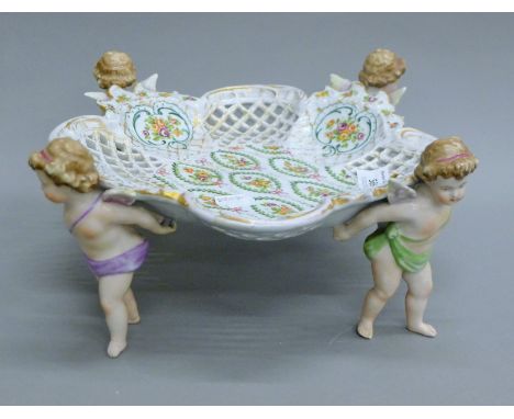 A Continental ceramic tazza decorated with four cherubs. 32 cm diameter.