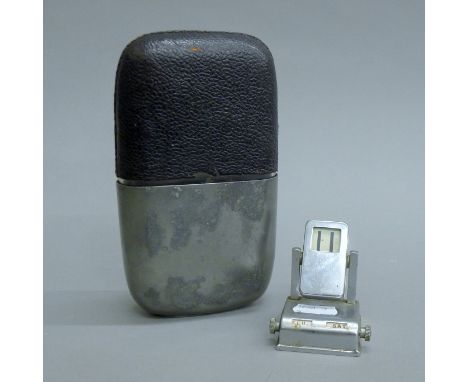 A spirit flask and a desk calendar. The former 17.5 cm high.