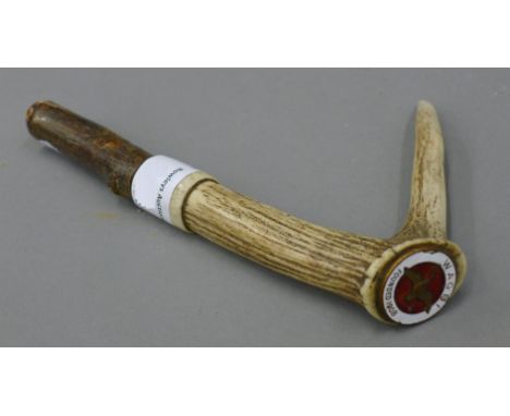 A WAGBI enamel badge, mounted on an antler walking stick handle. 