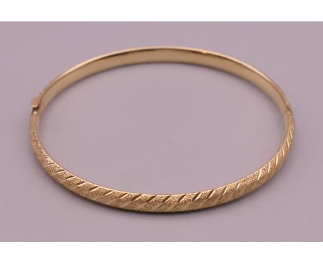 A 10 K gold bangle form bracelet.  6 cm internal diameter. 3.9 grammes. 