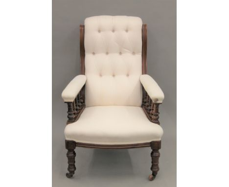 A Victorian upholstered button back walnut open armchair.  69 cm wide.
