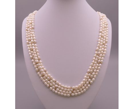 A four strand pearl necklace with 14 ct gold clasp.  60 cm long. 