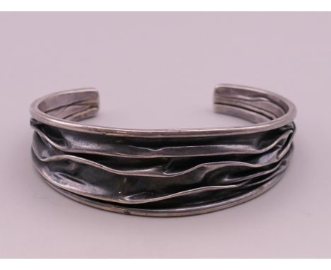 A modernist silver bangle.  6.5 cm wide.