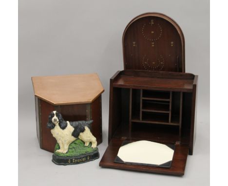 A table top bureau, a coal box, a doorstop and a bagatelle board.