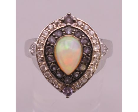 A silver, opal and cubic zirconia ring. Ring size V/W. 