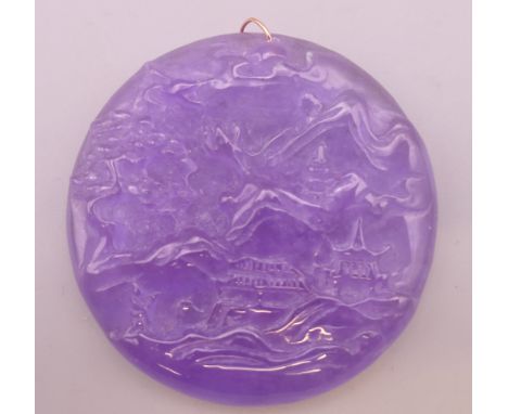 A gold mounted lilac jade pendant.  5.5 cm diameter.