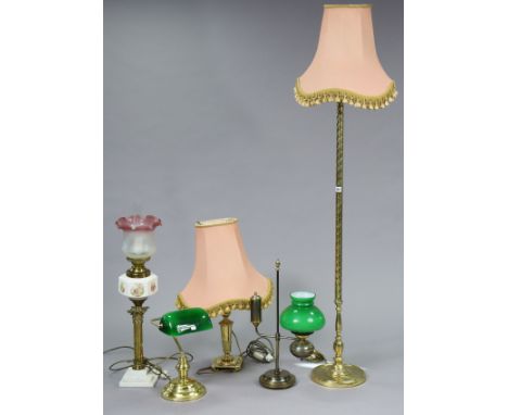 A brass standard lamp with a spiral-twist centre column &amp; on a circular base, with shade; &amp; four various table lamps 
