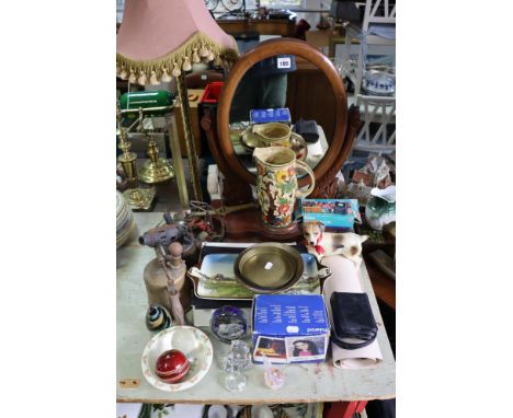 An early 20th century mahogany oval swing toilet mirror with a hinged compartment to the serpentine-front platform base, 45cm