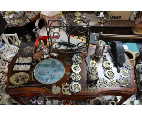 A collection of horse-brasses; a wrought-iron magazine-rack; a silver plated candlestick; various items of household linen, e