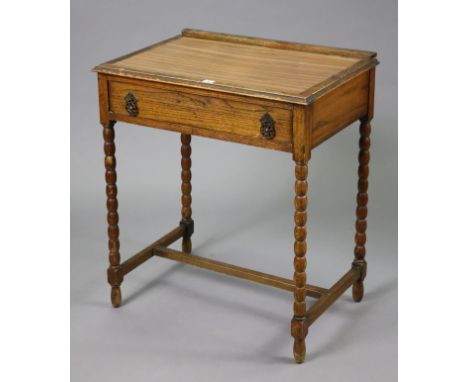 A 1930’s small oak side table fitted with a frieze drawer &amp; on bobbin-turned legs, 68.5cm wide x 76.5cm high x 46.5cm dee