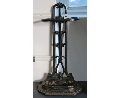 A Victorian-style black painted case-iron umbrella stand 58cm high; an early 20th century mantel clock; a two-division tea ca