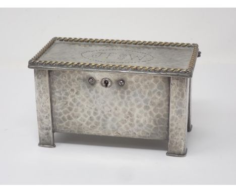 A hammered pewter Arts and Crafts two division Tea Caddy in the form of a Black Mountain Coffer with brass rope twist rim and