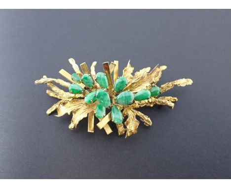 A Jade Spray Brooch the rustic plaque set pear shaped jade pieces, stamped 14K, approx 6.5cm long, approx 16gms 
