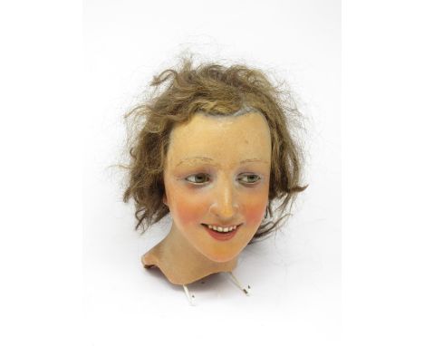 An early 20th Century female wax mannequin Head with plaited brown hair and brown eyes 