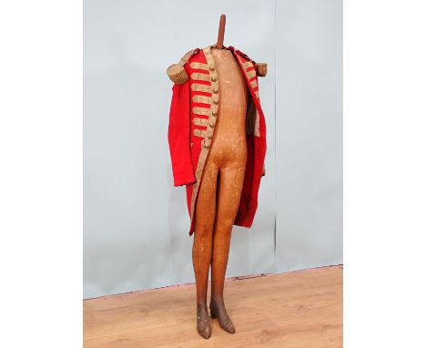 A late 18th or early 19th Century British Army type 'Red Coat' with brass button initialled 'M', resting on an antique papier