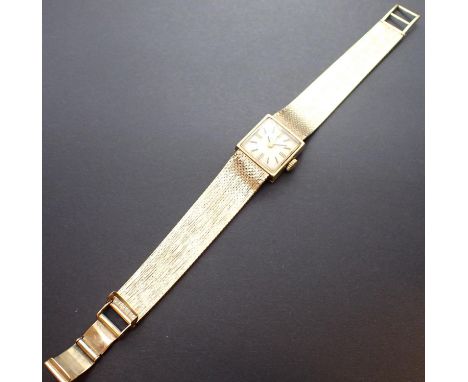 A Lady's manual Tissot Wristwatch, the square champagne dial with hourly baton markers on 9ct gold flexible woven bracelet wi