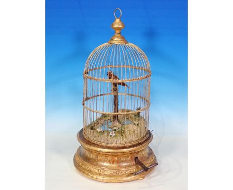 A singing bird Automaton within a domed gilt cage on a gilt wooden base, believed to be by J Lory of Paris, the bird having m