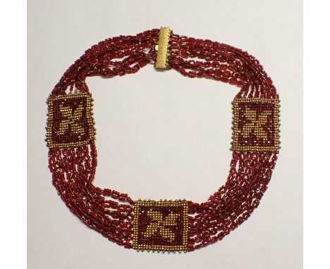 A garnet coloured and gilt metal Bead Collarette on scale engraved gilt metal clasp 