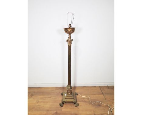 A brass Standard Lamp and shade with corinthian capital, reeded column, on stepped square base with lion paw supports, 4ft 7i