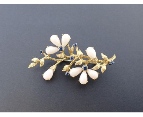 A Sapphire and Coral Flower Spray Brooch the openwork foliate plaque claw-set round sapphires to flower centres within jade c