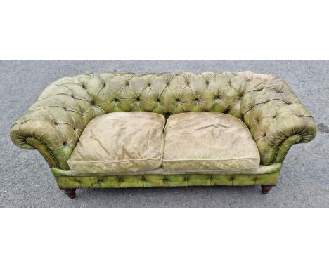 A green leather button upholstered Chesterfield Settee on turned tapering supports, (reupholstered by Joseph Crisp of London)