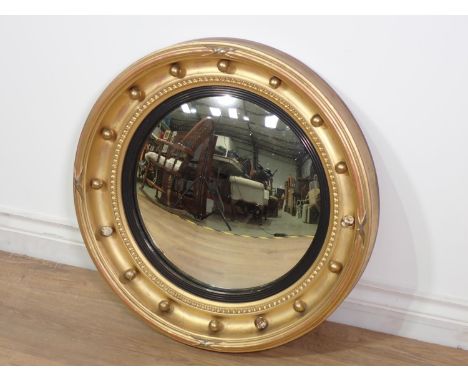 A Regency gilt Convex Wall Mirror with ball frieze and ebonised slip, 1ft 11in Diam. 