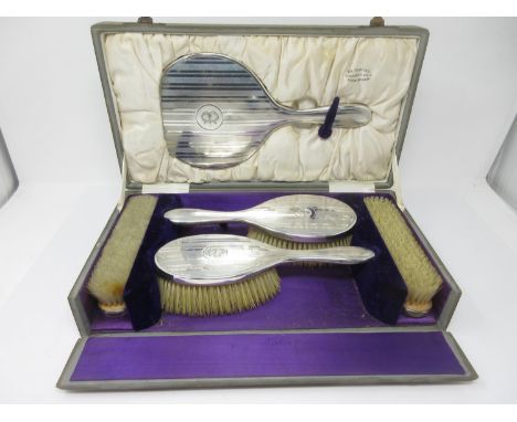 A George V silver mounted five-piece Dressing Table Set with engine turning and initial B, London 1922, in case. 