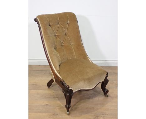 A Victorian button upholstered Nursing Chair with scrolled back and raised on scrolled front supports and casters 