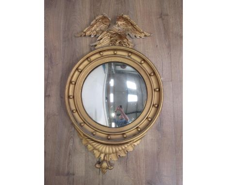 A 19th Century gilt Convex Wall Mirror with eagle surmount and ball frieze, 3ft 7in H 