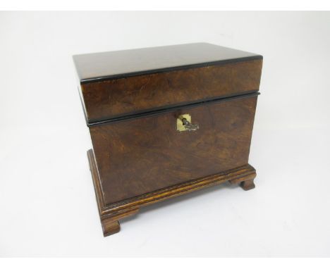 A walnut Jewel Box with hinged lid enclosing tray and small inlaid compartment on ogee bracket feet, 8in 