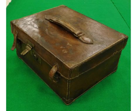 A vintage leather fishing holdall with green baize-lined compartments