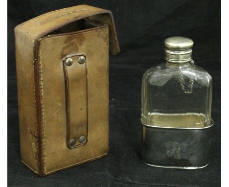 A vintage leather carrying case containing a cut glass flask with plated mounts inscribed "FN", the case stamped "R.S Buller"
