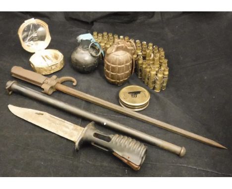 A collection of militaria to include a pineapple grenade stamped "C.A. 23MD" and a "baseball" grenade, two various bayonets, 