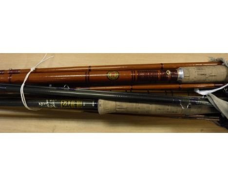 A collection of five assorted fishing rods comprising three split cane examples, one fibreglass model and one graphite model 
