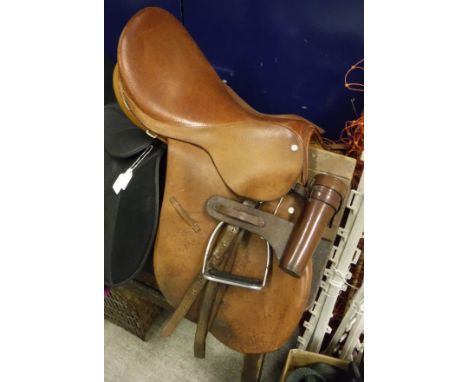 A general purpose Hayes of Cirencester brown leather saddle with stirrups, together with a leather saddle flask holder