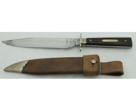 A large wooden-handled hunting knife in leather sheath/scabbard CONDITION REPORTS Pitting on both sides of the tip of the bla