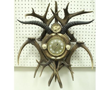 A brassed barometer housed in decorative antler frame with eagle finial  