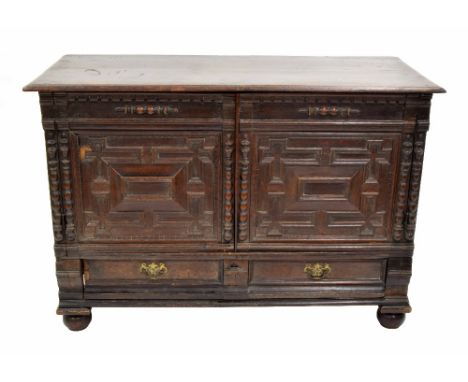 18th century oak moulded low cupboard, the moulded top over two carved panelled cupboard doors and two short drawers to the s