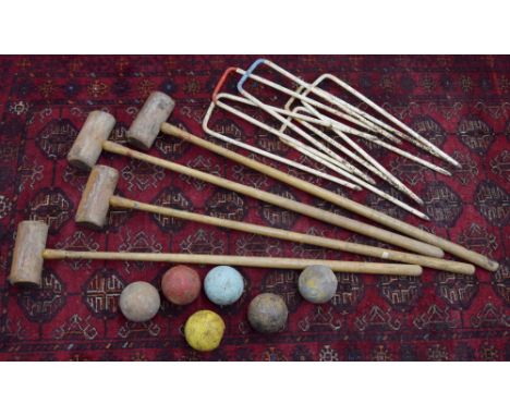 Vintage lawn croquet set, with four mallets, six hoops and six balls