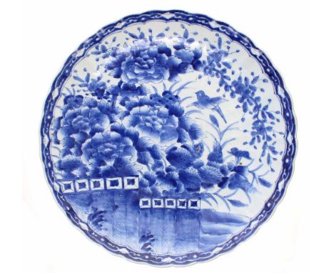 Japanese blue and white porcelain charger, densely decorated with birds within trees within repeated geometric border around 