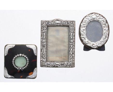 Contemporary tortoiseshell and silver mounted miniature photo frame, make H M, London 1983, 3" high, together with a repousse