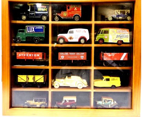 Wall mounted display case, hinged front, fifteen compartments, 33 x 30 cm complete with Lledo, OO scale wagons etc. P&amp;P G