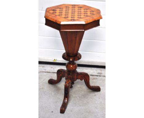 A Victorian walnut octagonal sewing and games table on carved tripod  support with silk lined sectional interior, height 73cm