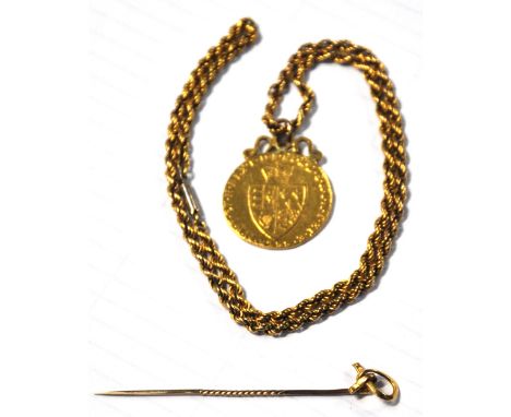 A George III guinea with mount to the top, 1788, suspended from a yellow metal rope effect chain, also a yellow metal stick p