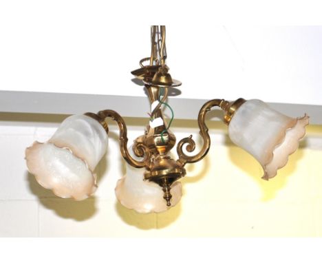 A brass three light ceiling light with shaped glass shades, drop approx 30cm.